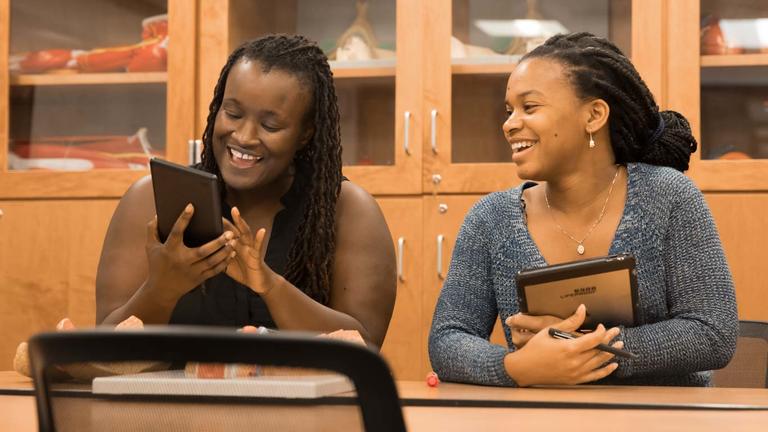 two students viewing a tablet