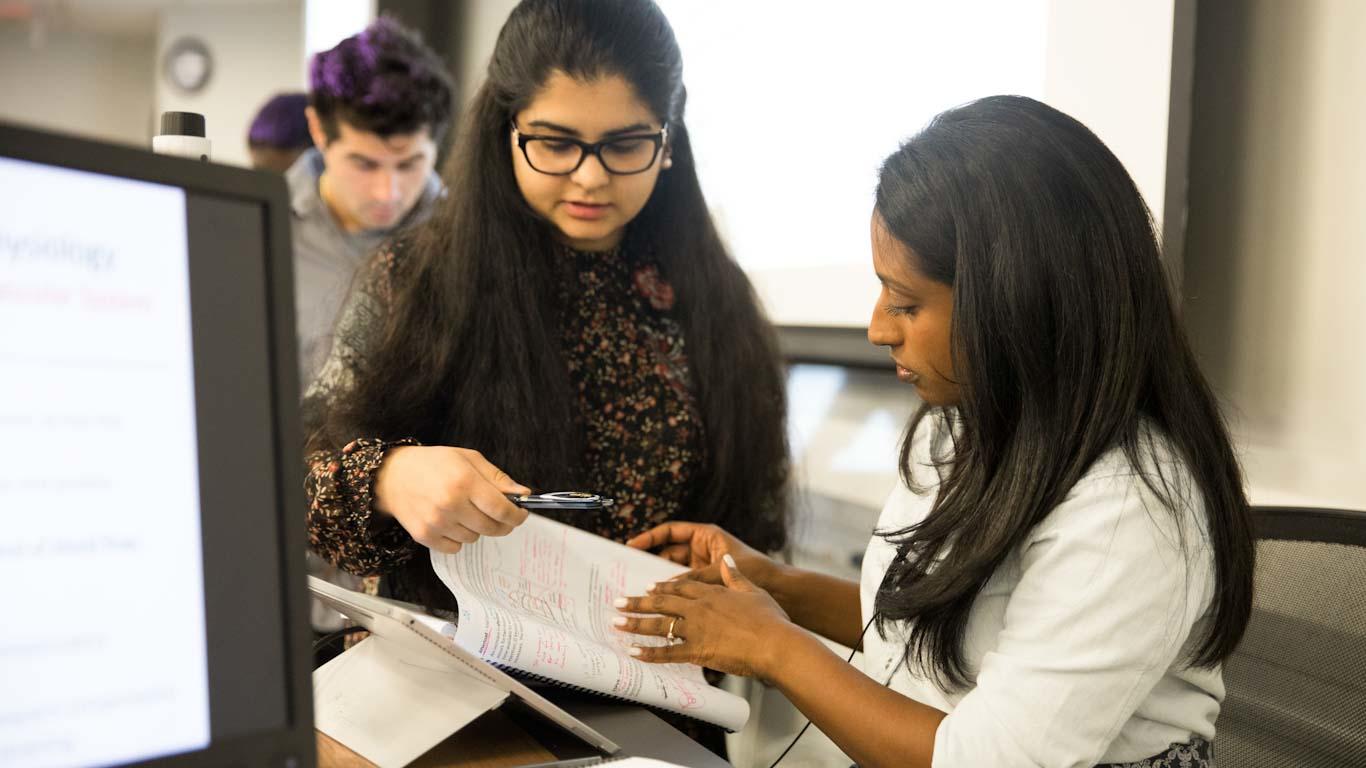 Teacher and student checking work